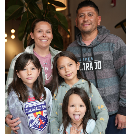 Family smiling inside MT Tattoo Collective tattoo studio in Denver