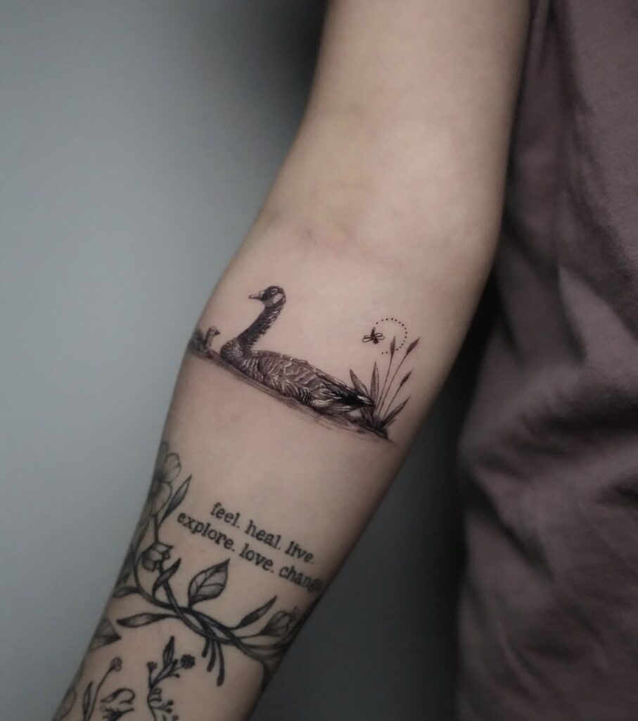Fine line duck with script lettering tattoo
