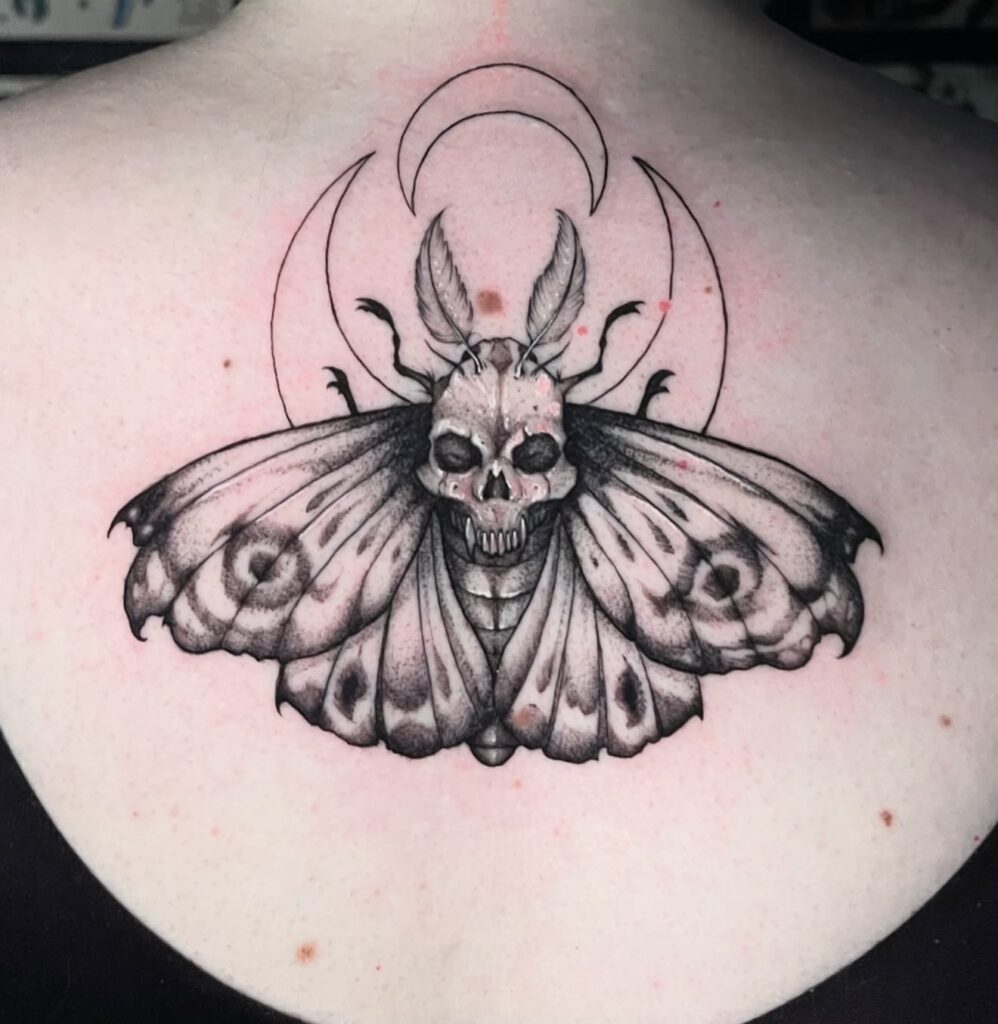 Geometric skull moth fine line tattoo on back