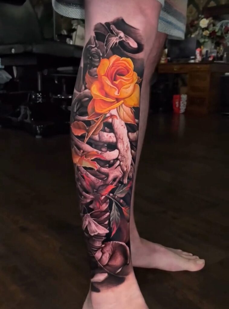Color realism orange rose and skeleton leg tattoo